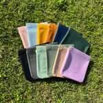 A range of colorful PU leather coin bags on grass